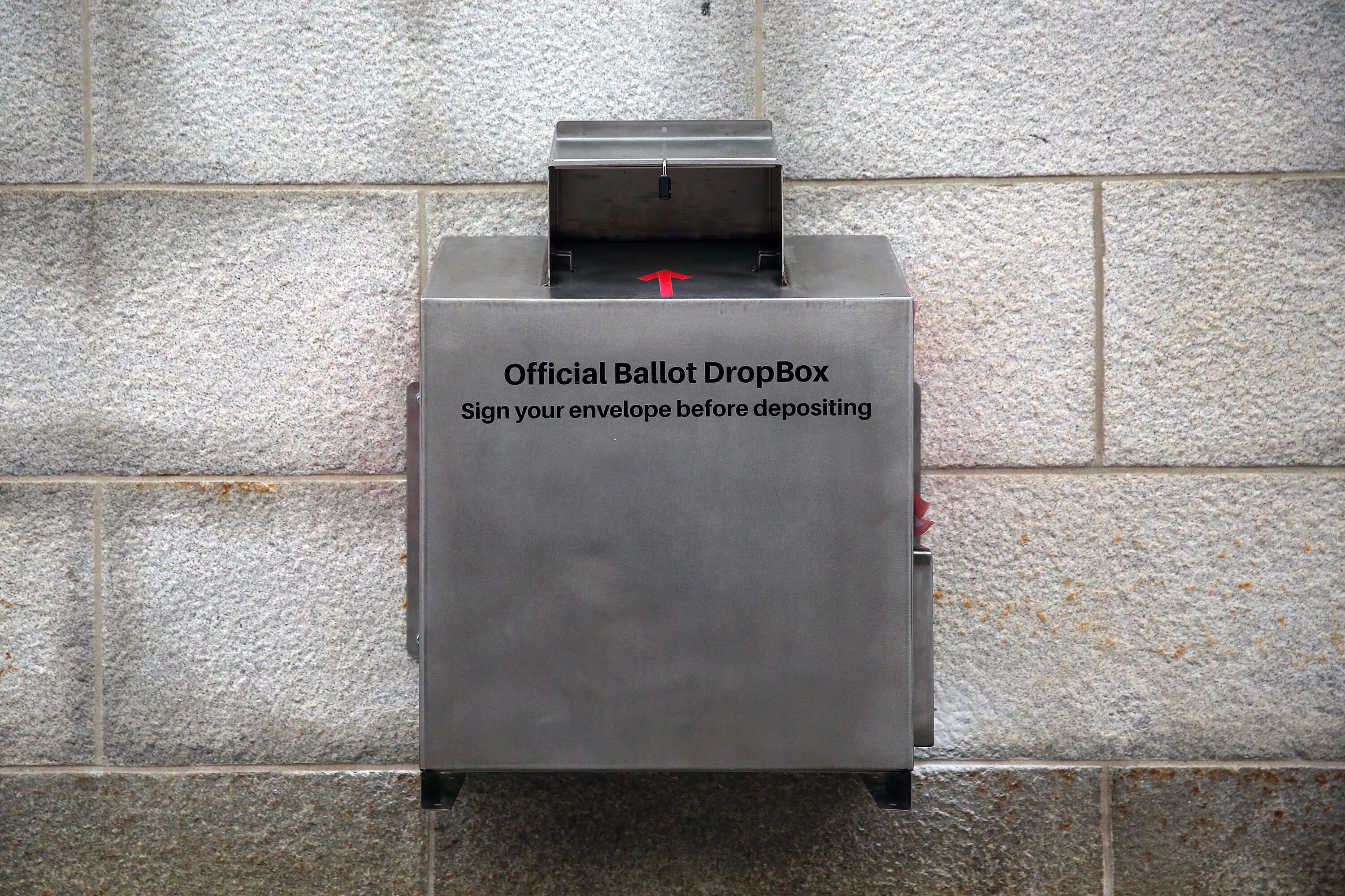 A ballot drop box with a sign that says 