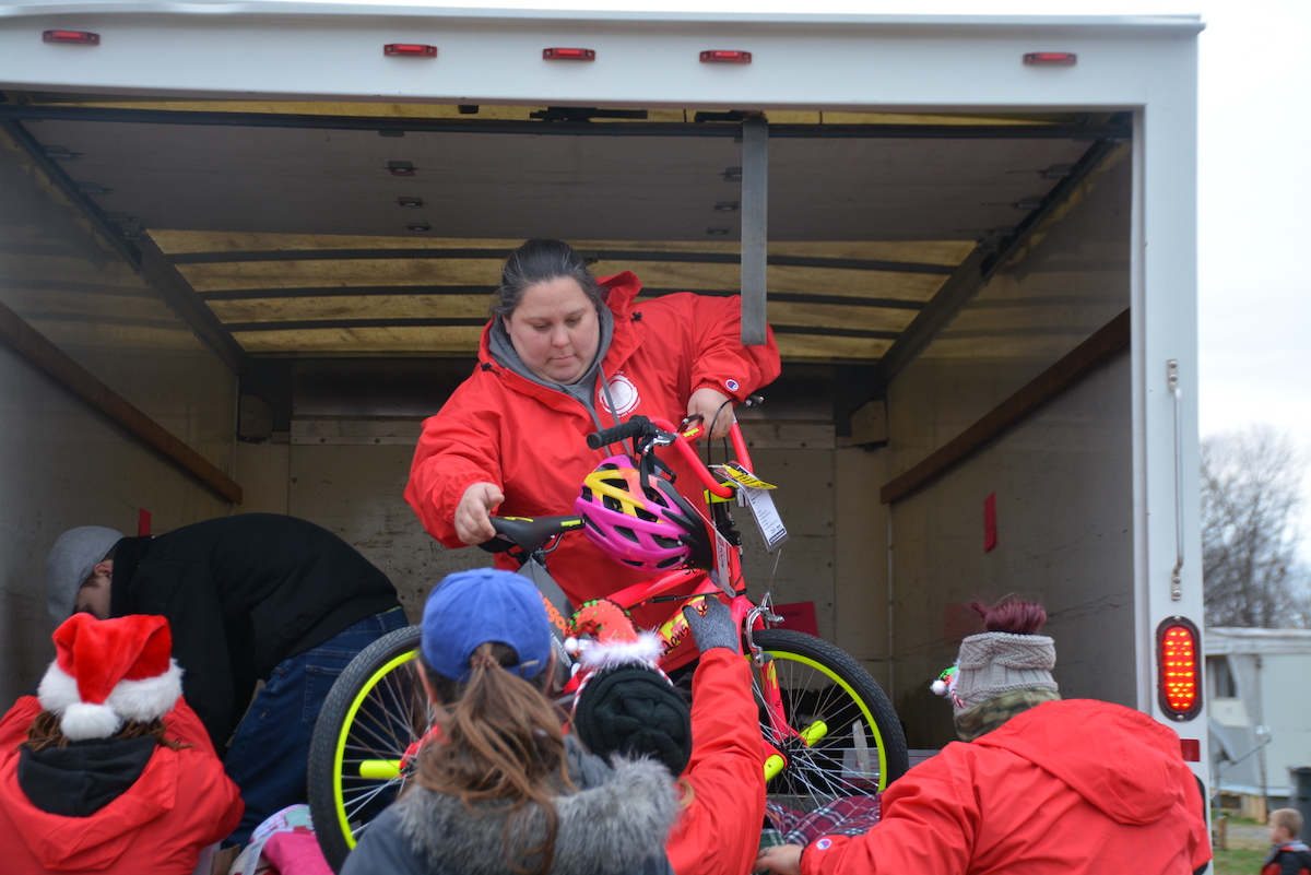 Volunteers readying a new bike for a Campbell Heights child.