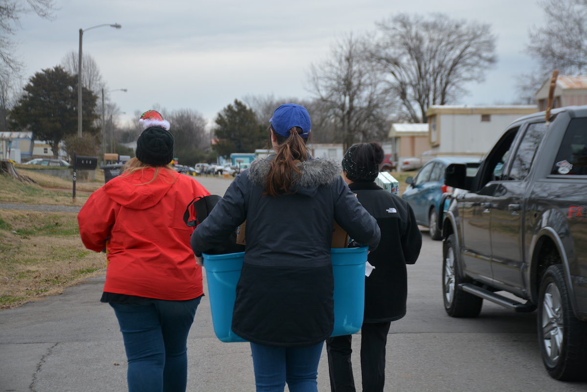 Volunteers carrying gifts.