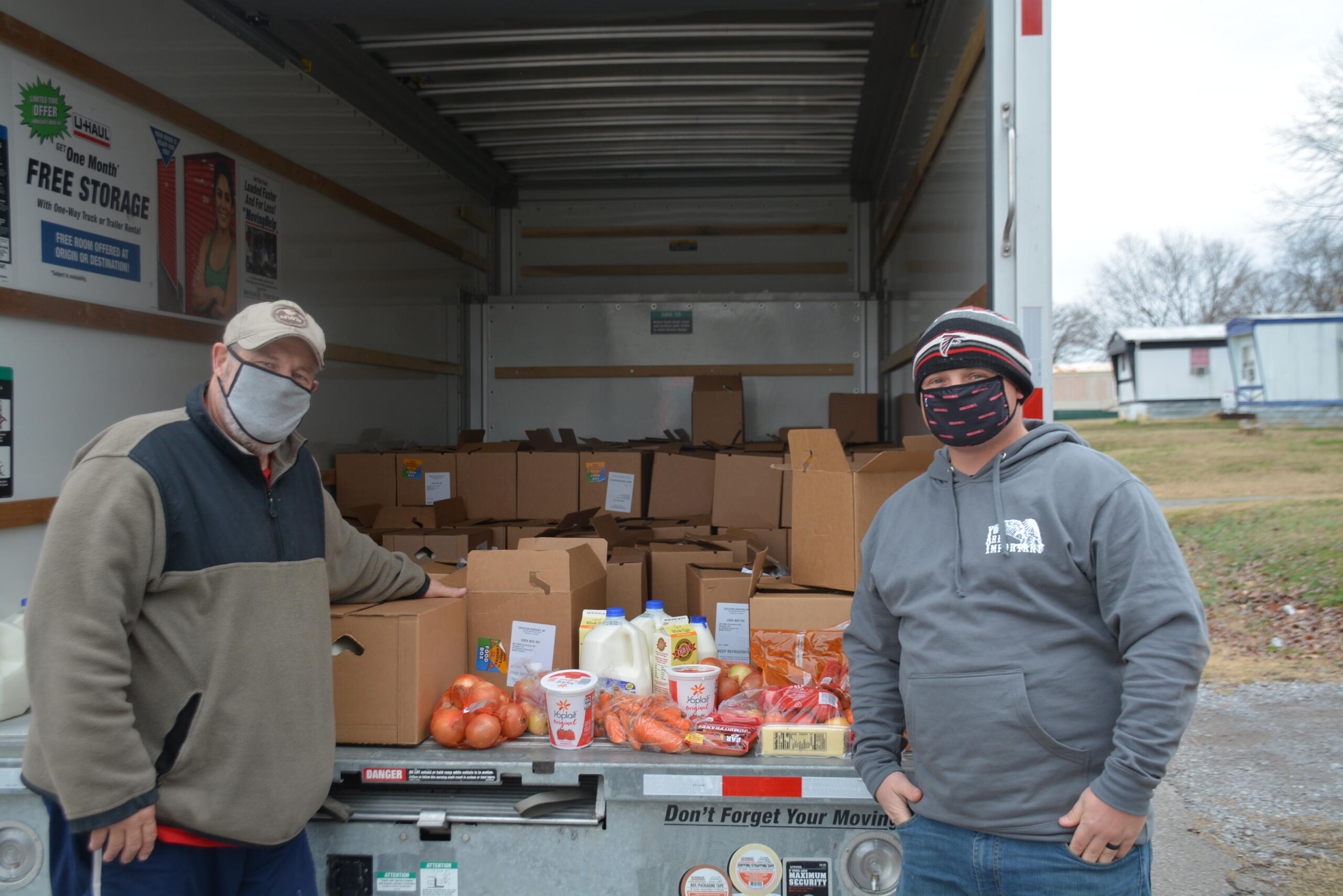 Ron Fahy and a 2nd Battalion volunteer withFort Care food boxes.