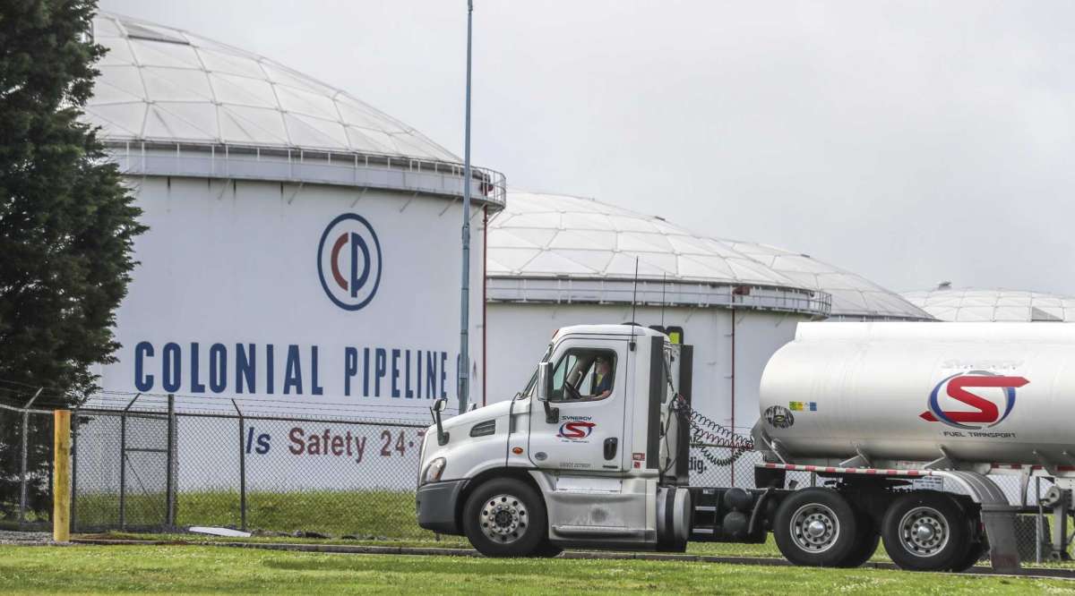 Gasoline tankers pass by the Colonial Pipeline storage tanks located in Austell, Georgia, on May 10, 2021, as they enter the Marathon Powder Springs Terminal. A ransomware attack shut down the Alpharetta-based Colonial Pipeline that delivers roughly 45% of fuel consumed on the East Coast. (John Spink/The Atlanta Journal-Constitution/TNS)