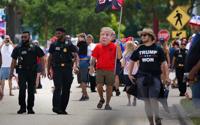 Wearing a cutout of Donald Trump's face, Jeff LeBaron of Bradenton attends a rally for former President Donald Trump at the Sarasota Fairgrounds on July 3, 2021. DANIEL WAGNER / HERALD-TRIBUNE