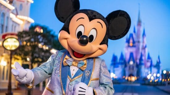 mickey mouse in front of cinderella castle
