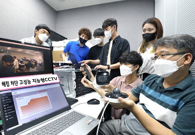 This photo provided by LG Uplus Corp. shows the mobile carrier's employees testing new technology to prevent the hacking of intelligent CCTV systems.