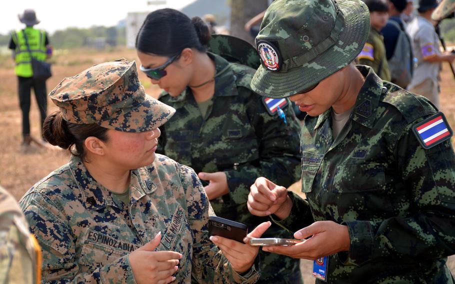 A U.S. Marine and a Thai soldier exchange contact information ahead of a Cobra Gold amphibious assault on Hat Yao Beach, Thailand, March 1, 2024.